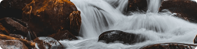 Waterfall rushing over dark stones